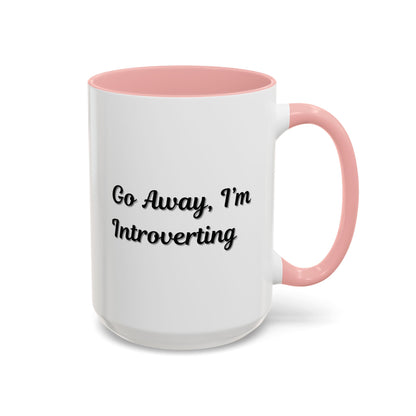Ceramic coffee mug with "Go Away, I'm Introverting" text, 11 oz, black handle, ideal for introverts.