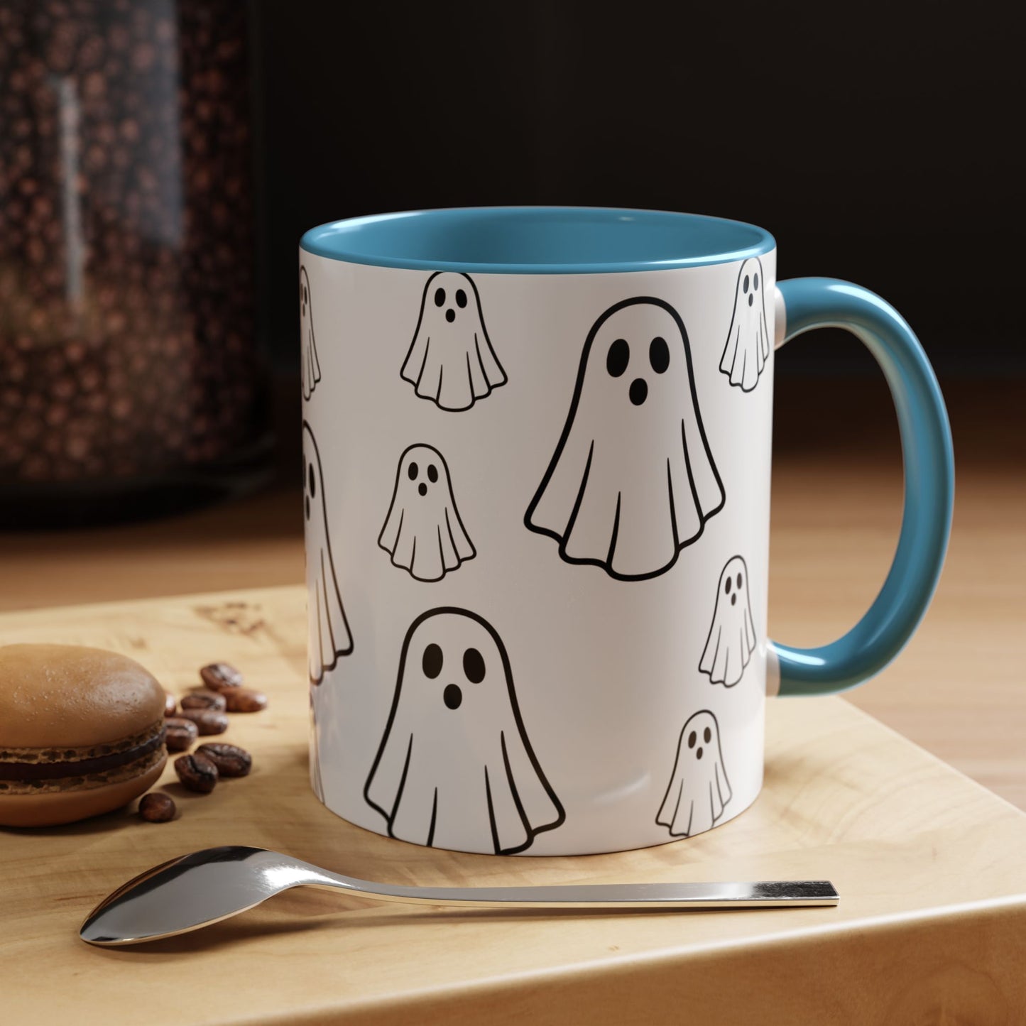 White ceramic coffee mug with ghost pattern design, 11oz, featuring a cute Halloween-themed print, ideal for spooky season drinks.