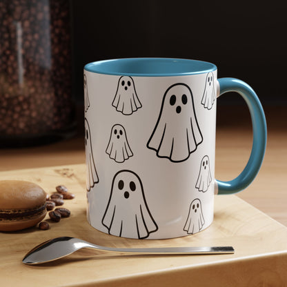 White ceramic coffee mug with ghost pattern design, 11oz, featuring a cute Halloween-themed print, ideal for spooky season drinks.
