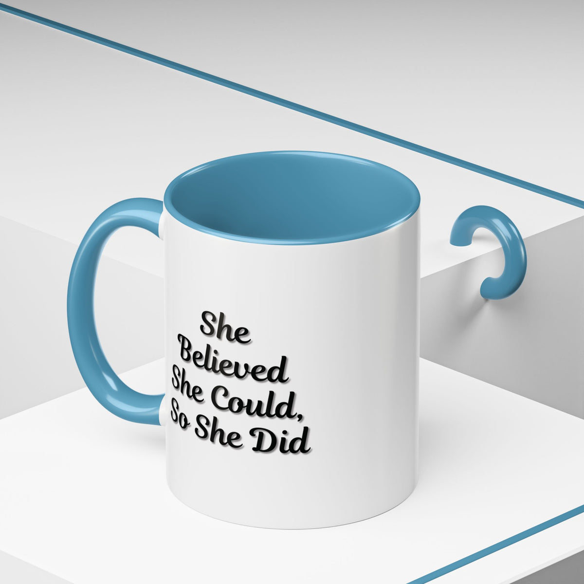Motivational coffee mug with "She Believed She Could, So She Did" quote, white ceramic mug with black text, Printify brand.