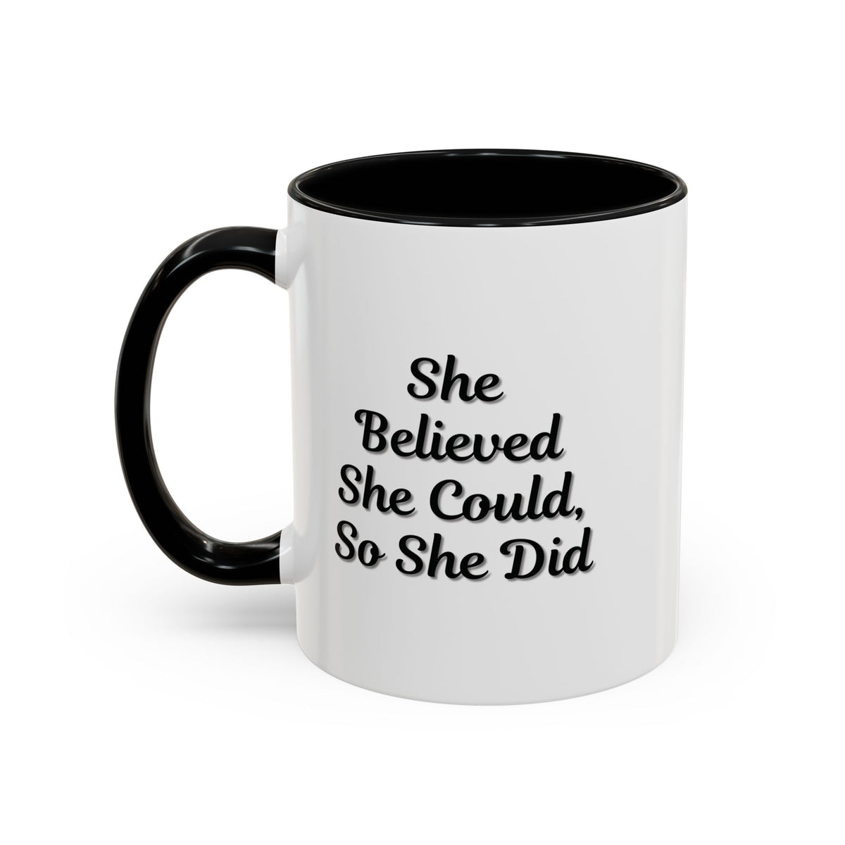 Motivational coffee mug with the phrase "She Believed She Could, So She Did" in black text on a white ceramic mug.