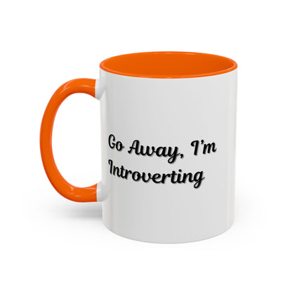 Ceramic coffee mug with "Go Away, I'm Introverting" phrase, 11 oz size, featuring a white background and black text.