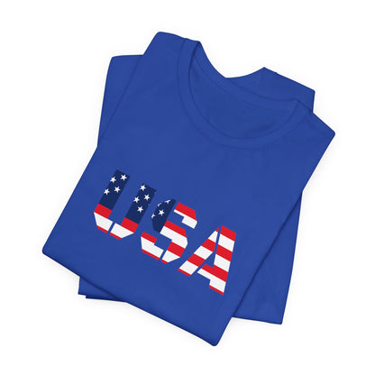 USA flag text T-shirt by Printify featuring patriotic Fourth of July design, shown with front view and bold red, white, and blue colors.
