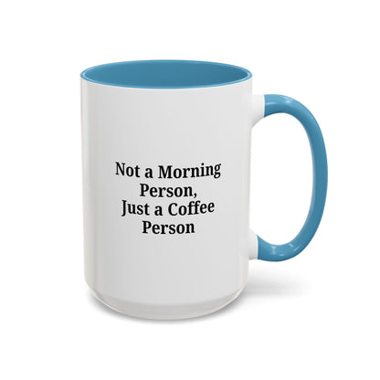 Ceramic coffee mug with the phrase "Not a Morning Person, Just a Coffee Person" printed on white background