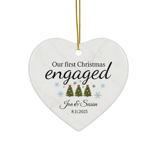 Ceramic "Our First Christmas Engaged" heart ornament by Printify, festive holiday decoration with engraved sentiment.