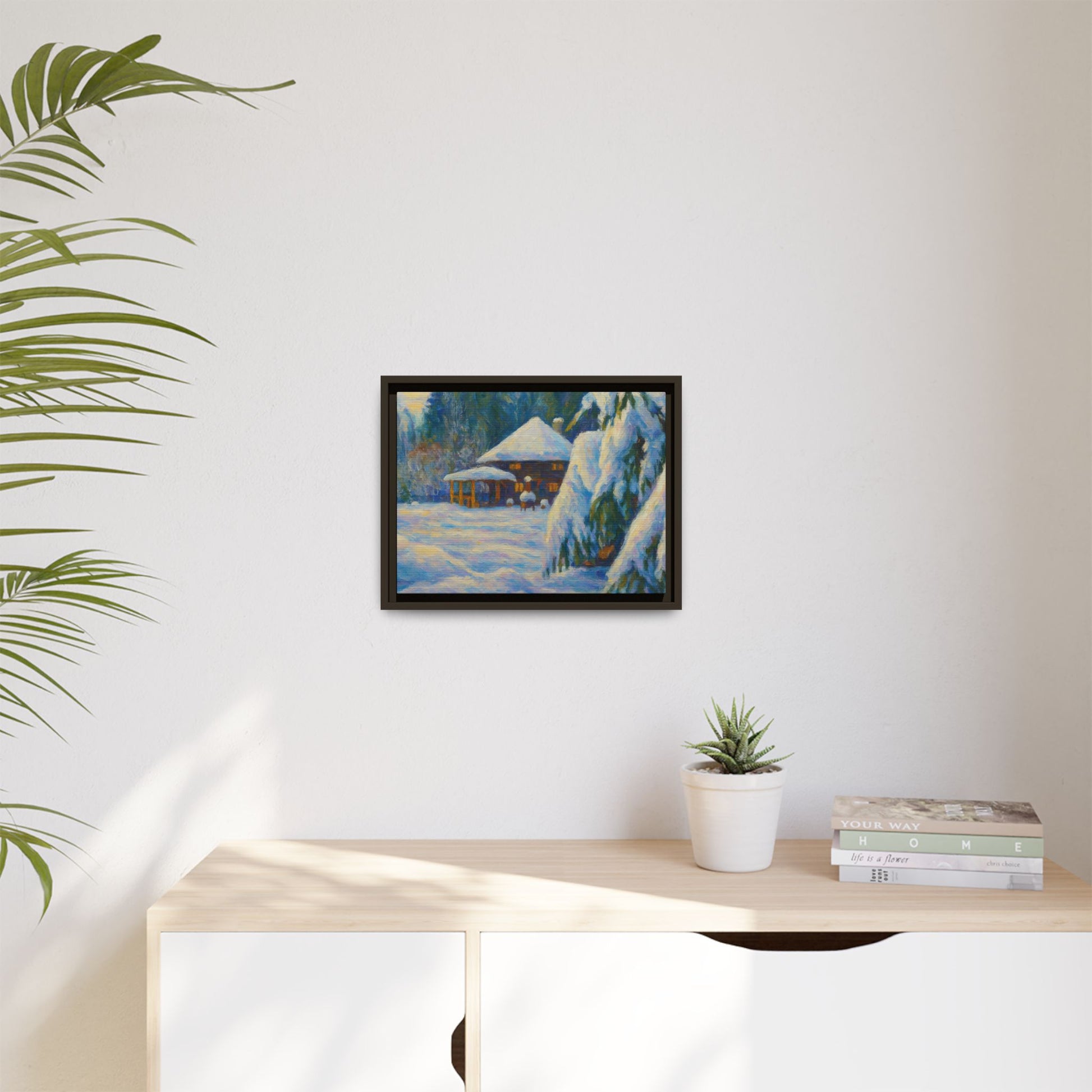 Framed matte canvas wall art of a snowy cabin winter landscape, featuring a cozy cabin surrounded by snow-covered trees.