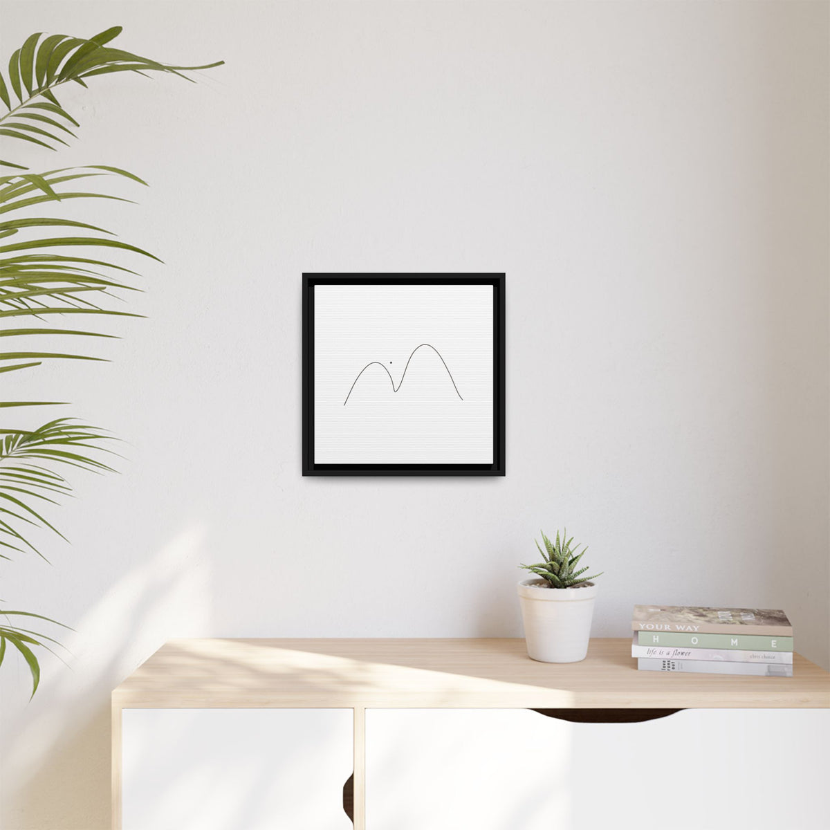 Minimalist mountain line art on framed matte canvas by Printify, featuring simple mountain peaks in black ink on white background.