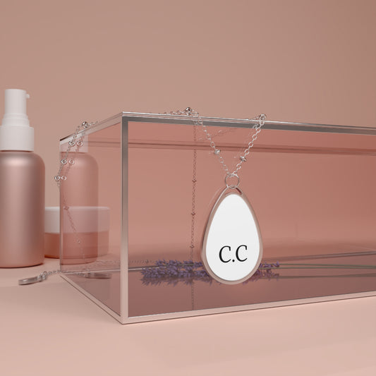 Personalized oval teardrop necklace with initial monogram pendant, silver-tone jewelry accessory featuring custom engraving.