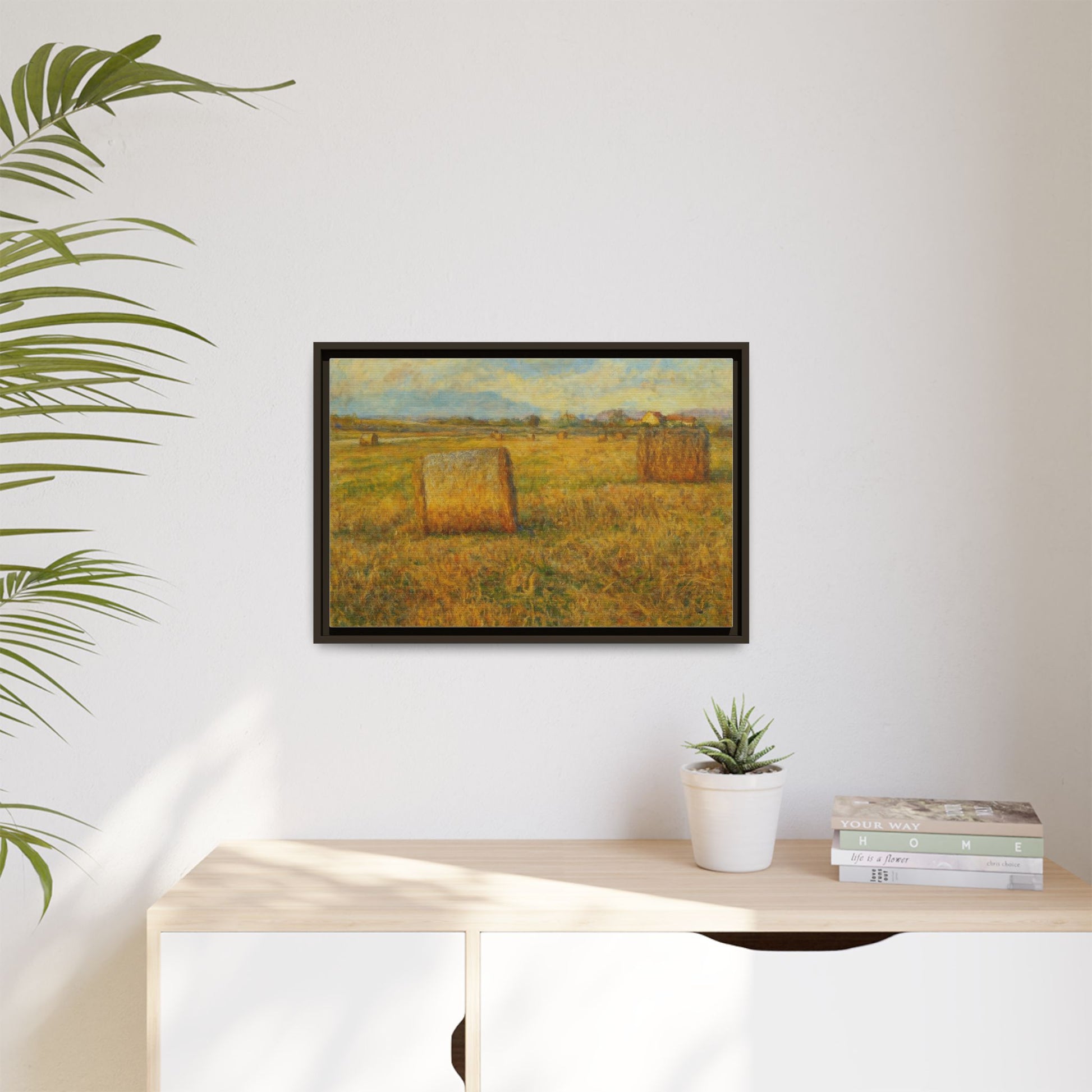 Framed matte canvas wall art featuring a rustic hayfield landscape print by Printify