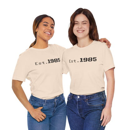 Vintage year graphic T-shirt by Printify, featuring "Est. 1985" design on a casual cotton tee.