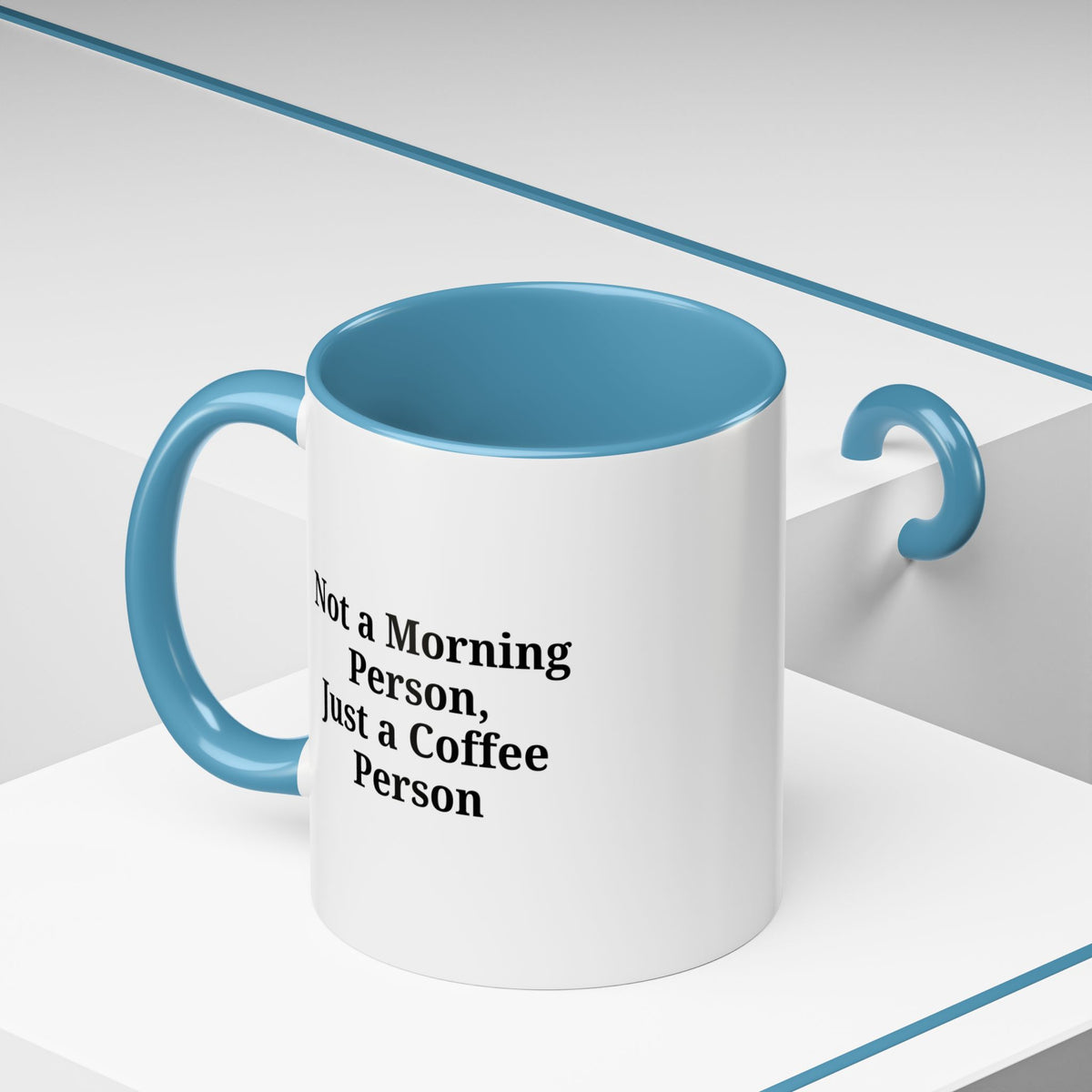 Ceramic coffee mug with the phrase "Not a Morning Person, Just a Coffee Person" in black text on a white background.