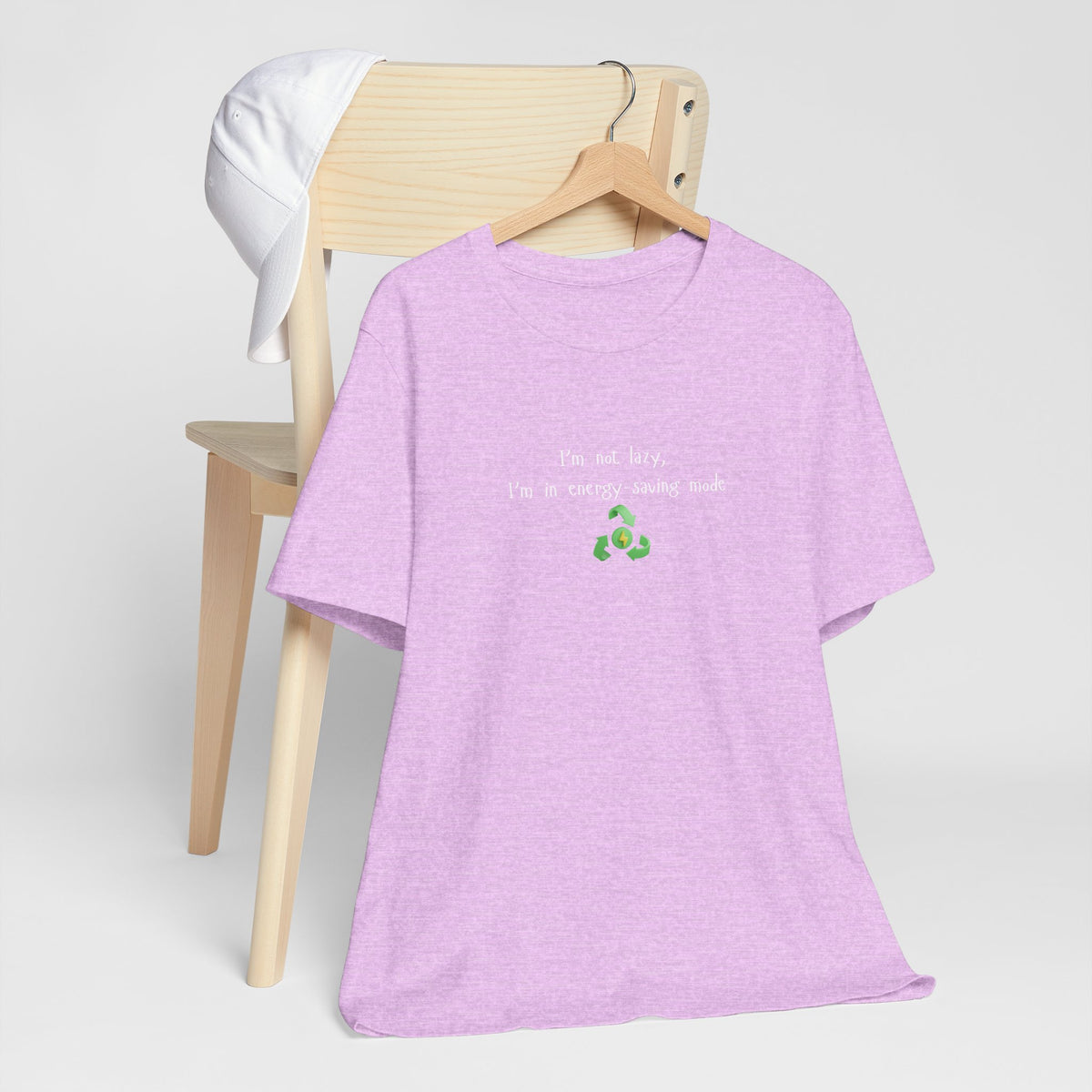 Eco humor T-shirt featuring the phrase "I’m Not Lazy, I’m an Energy-Saving Mock" printed on a casual unisex T-shirt by Printify.