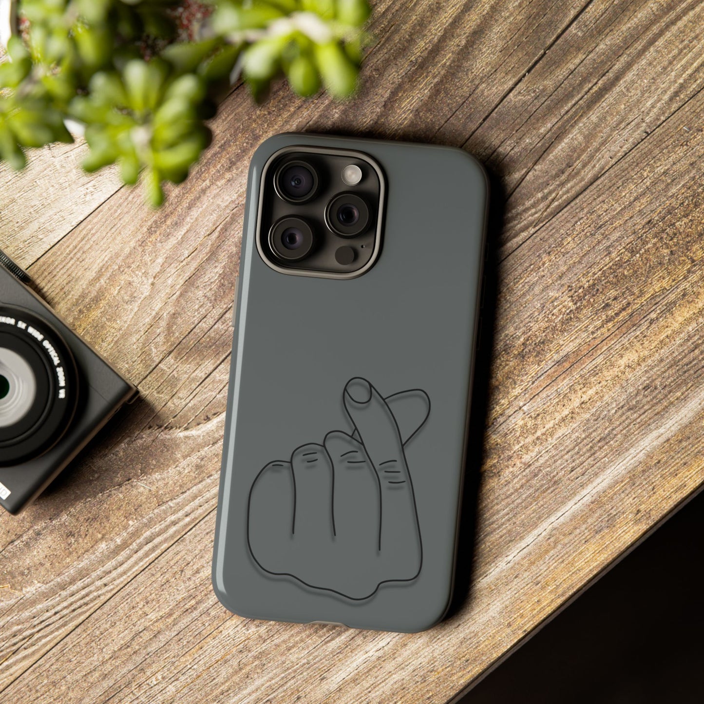 Silicone phone case with embossed Korean finger heart design, compatible with smartphones, by Printify.