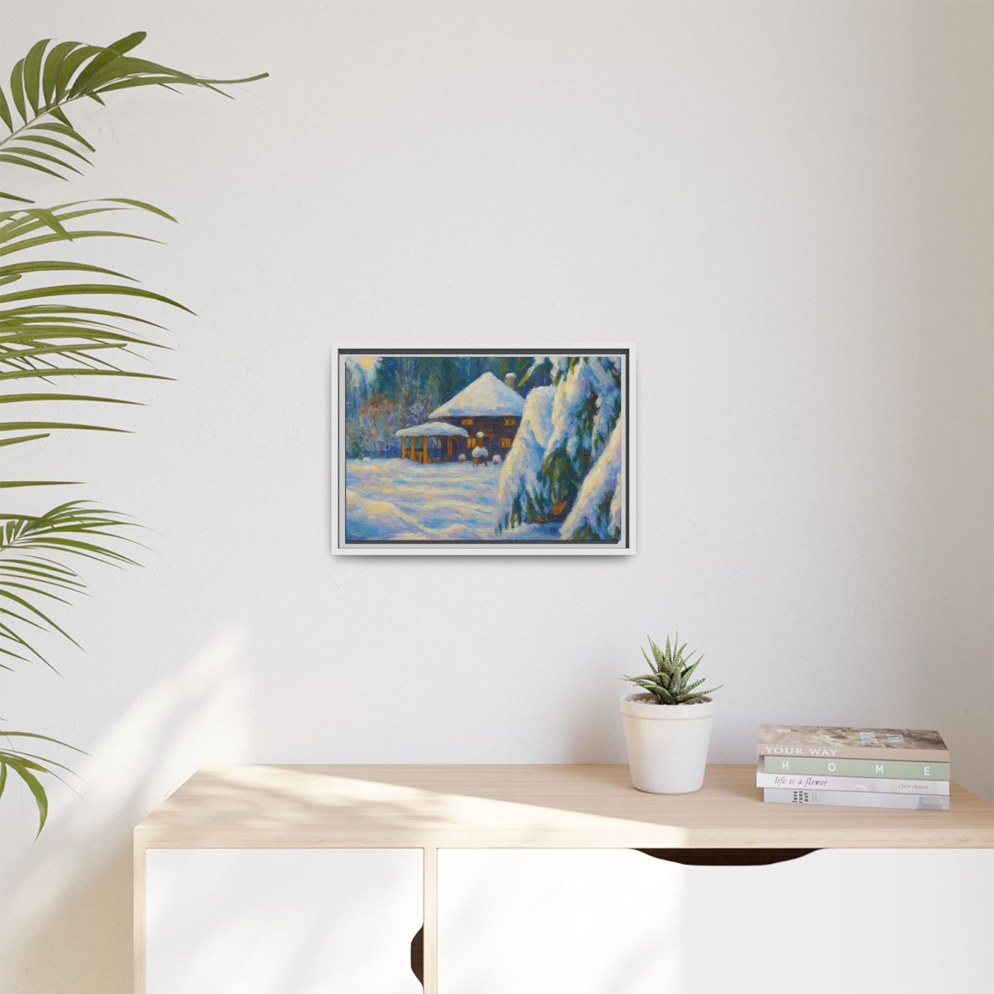 Framed matte canvas print of a snowy cabin winter landscape wall art by Printify, showcasing a cozy winter scene with trees and snow.