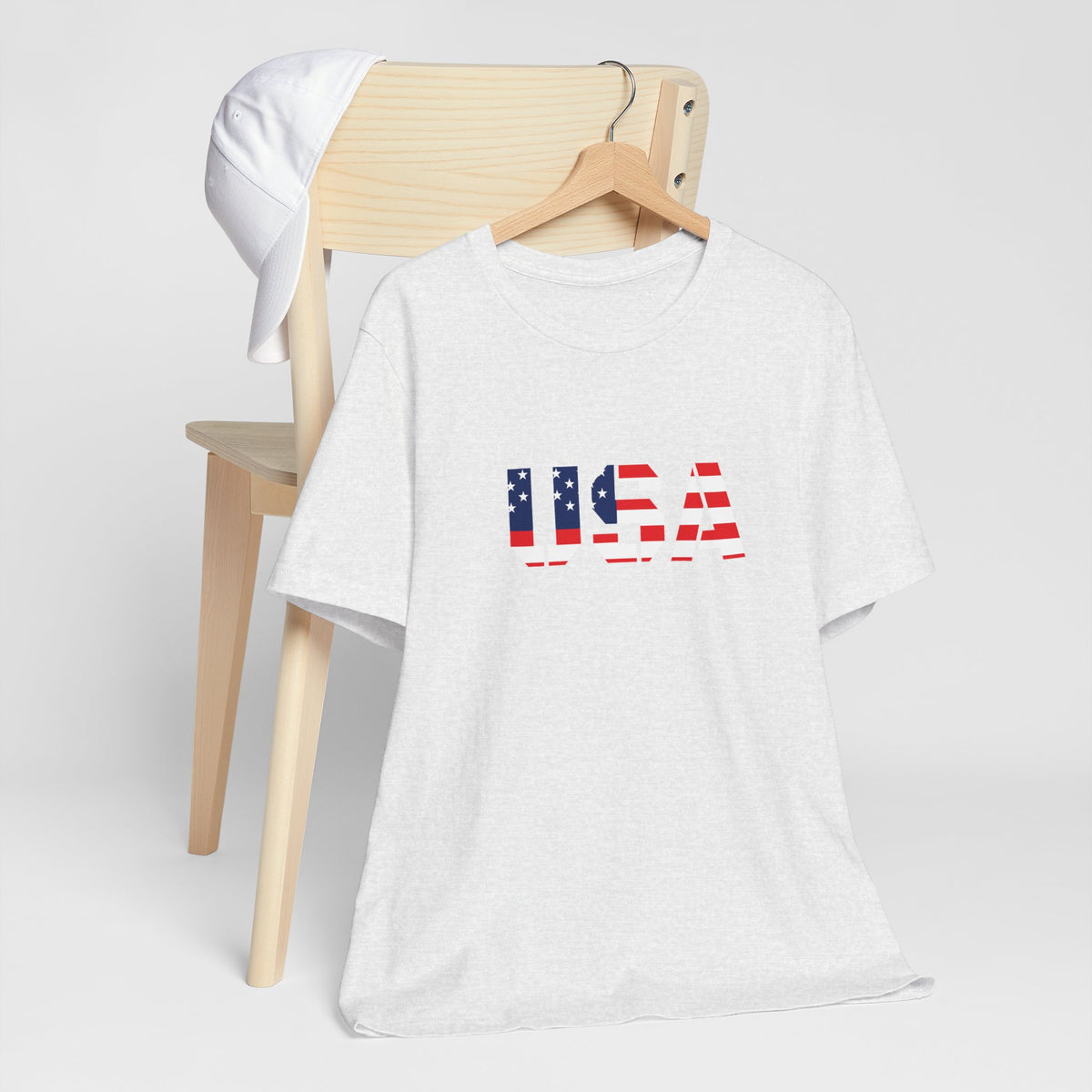 Red, white, and blue USA flag text T-shirt by Printify featuring patriotic Fourth of July design, casual graphic tee for Independence Day.