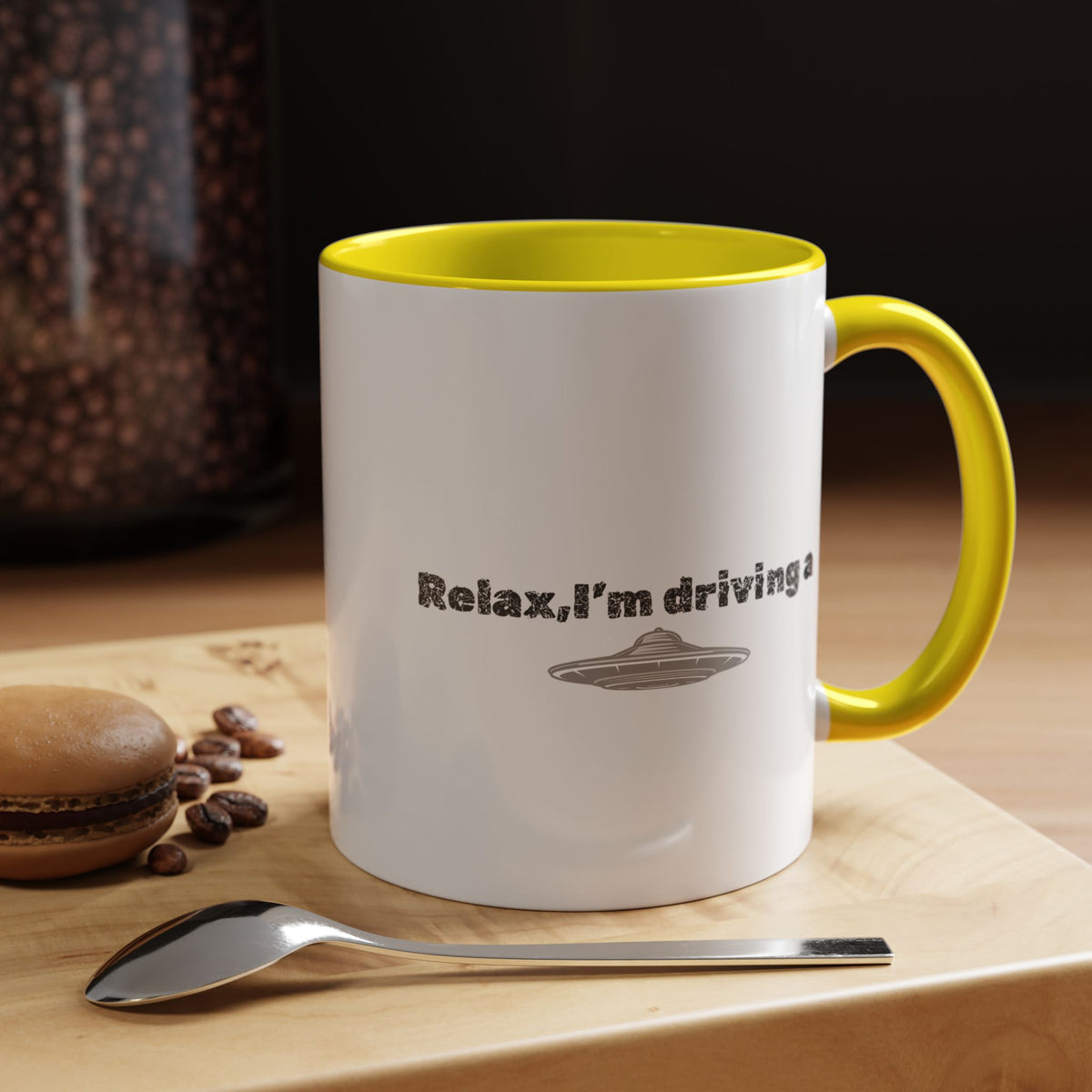 Ceramic coffee mug with UFO and "Relax, I’m Driving" text in black and white, 11 oz, featuring a playful alien design.