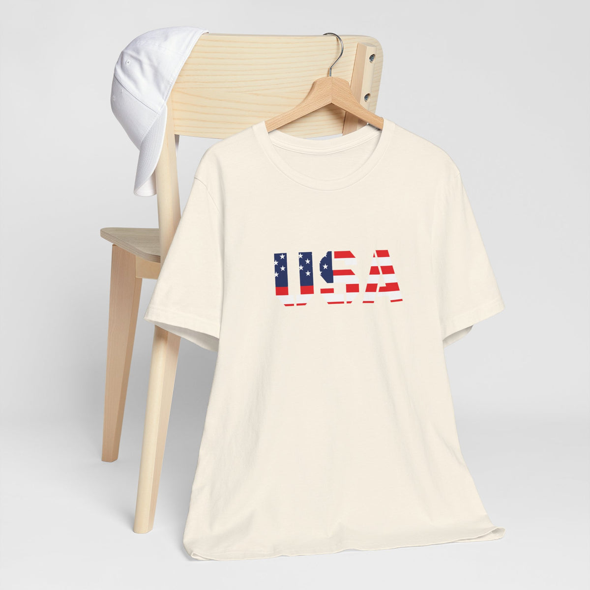 USA Flag Text T-Shirt by Printify featuring patriotic red, white, and blue design perfect for Fourth of July celebrations.