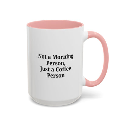 Ceramic coffee mug with the phrase "Not a Morning Person, Just a Coffee Person" printed on white ceramic, designed for coffee lovers.