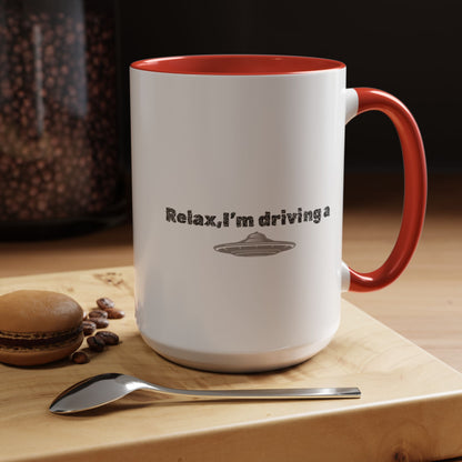 Ceramic coffee mug with UFO and space design, "Relax, I’m Driving" slogan, 11 oz size, printed by Printify.