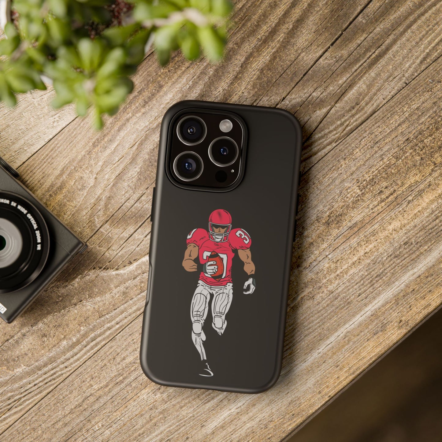 Black football player tough phone case for iPhone, protective sports-themed design by Printify, featuring a dynamic athlete graphic.