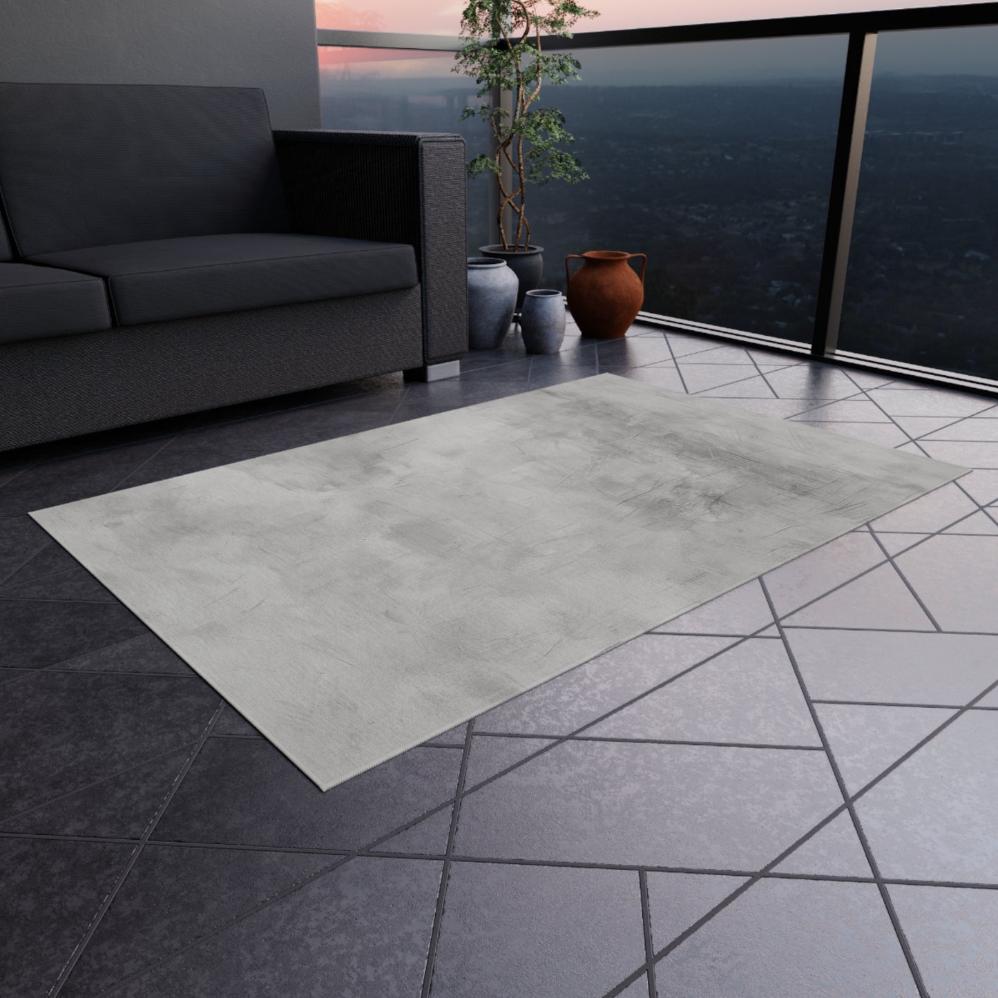 Modern gray outdoor rug by Printify, durable indoor-outdoor flooring for patios and decks, shown laid out on a patio surface.