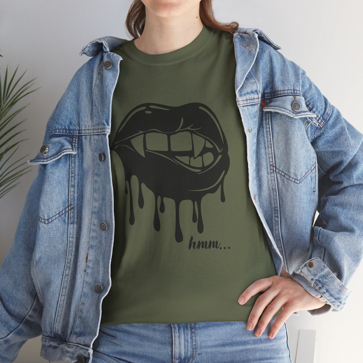 Black graphic T-shirt by Printify featuring a dripping lips 'hmm...' bite design on the front.