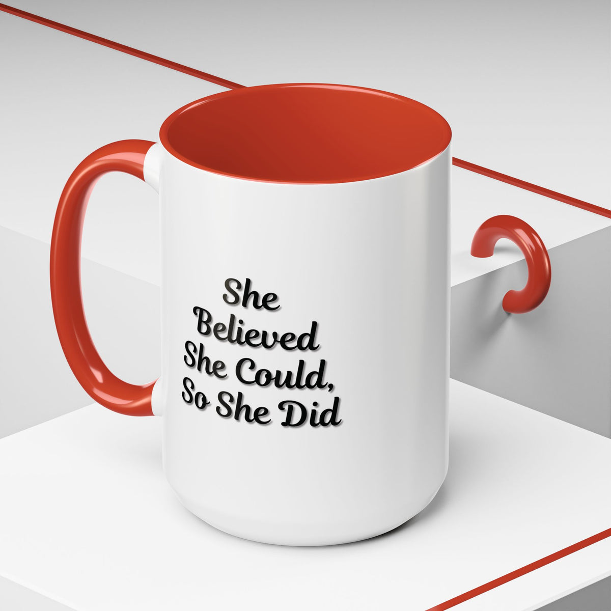 White ceramic motivational coffee mug with "She Believed She Could, So She Did" printed in black text, designed for daily inspiration.