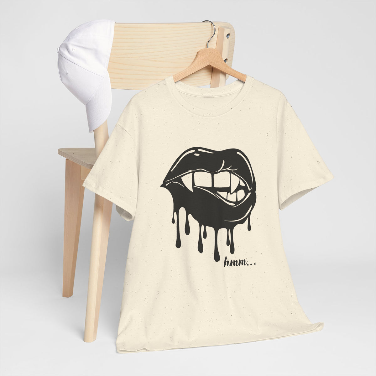 Black graphic t-shirt featuring dripping lips and 'hmm...' bite design by Printify, front view, casual style.