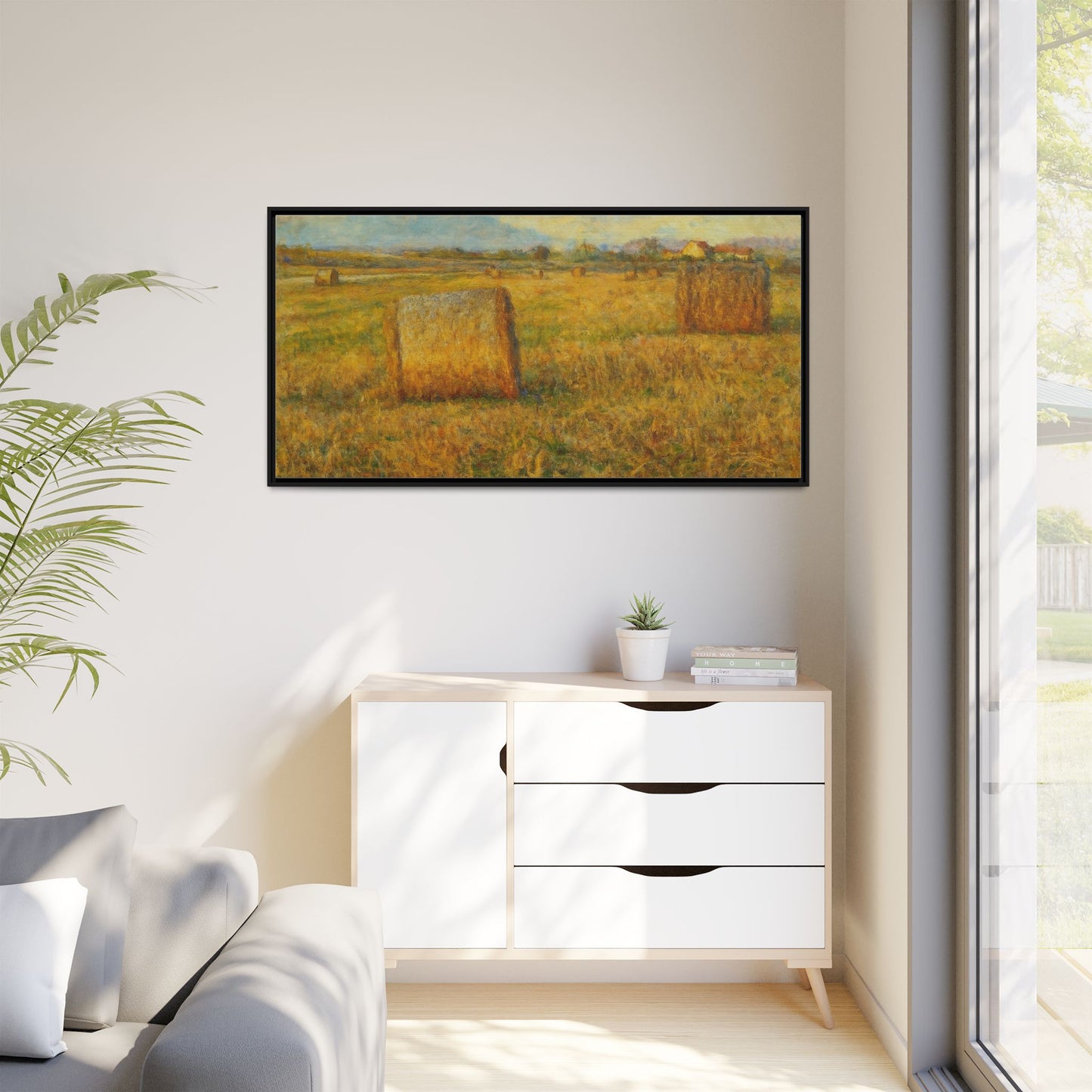 Framed matte canvas wall art of a rustic hayfield landscape print by Printify, showcasing a scenic countryside view.