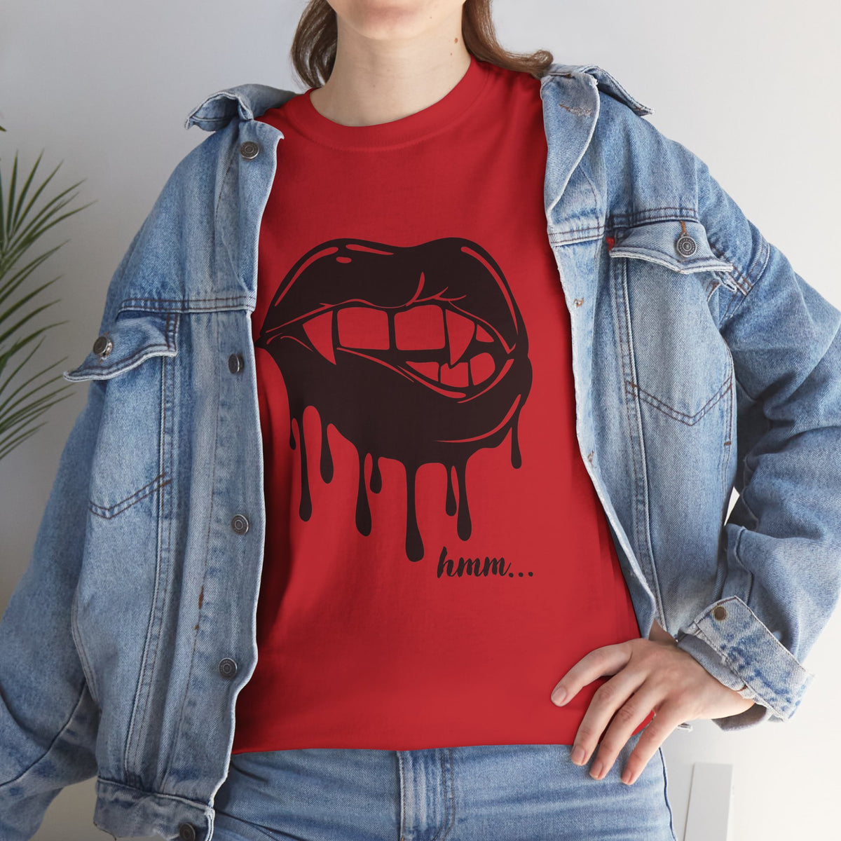 Graphic T-shirt featuring a dripping lips 'hmm...' bite design by Printify, with a bold, artistic illustration on the front.