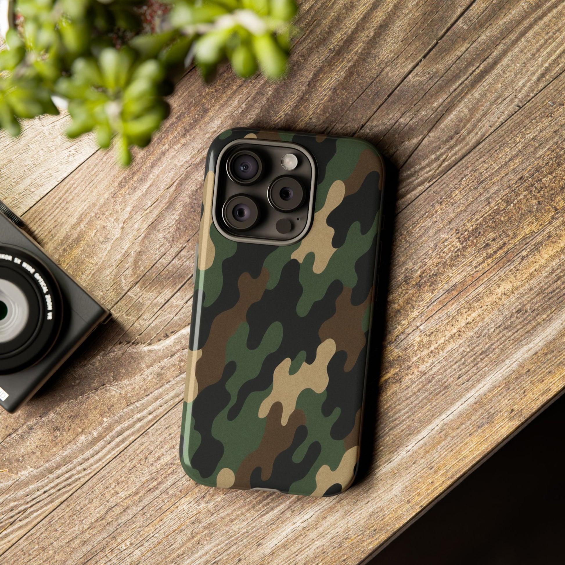 Rugged camouflage phone case by Printify featuring a tough, protective design with green and brown camo pattern.