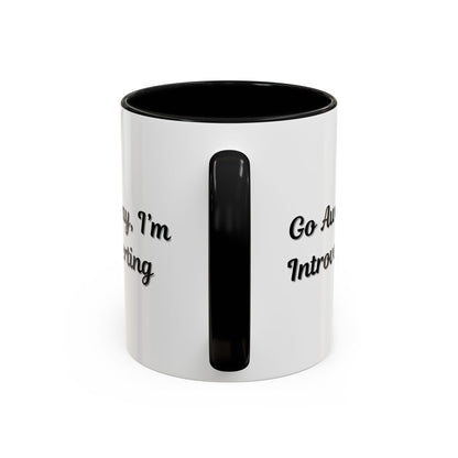 Ceramic coffee mug with "Go Away, I'm Introverting" slogan, 11 oz size, in white with black text, perfect for introverts.