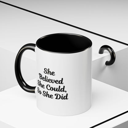 Motivational coffee mug with the quote "She Believed She Could, So She Did" in black text on a white ceramic mug.