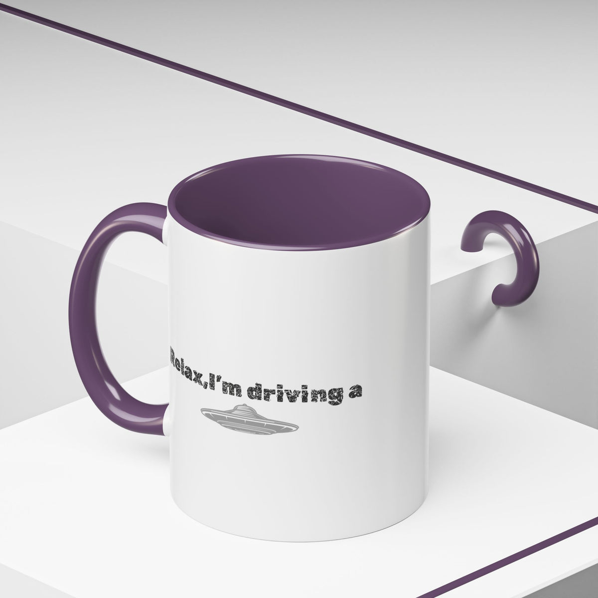 Ceramic coffee mug with UFO accent and "Relax, I’m Driving" text, available in 11 oz or 15 oz sizes by Printify.