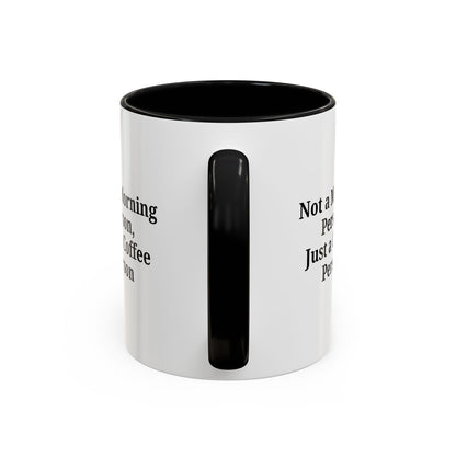 Ceramic coffee mug with "Not a Morning Person, Just a Coffee Person" text, featuring a white background and colorful lettering.