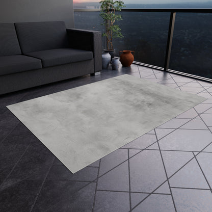 Modern gray outdoor rug by Printify, indoor-outdoor flooring ideal for patios and decks, shown laid out on a deck surface.