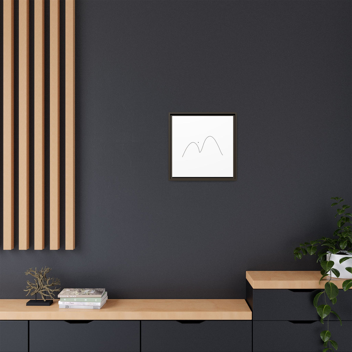 Framed minimalist mountain line art on matte canvas by Printify, featuring simple black mountain outline on white background.