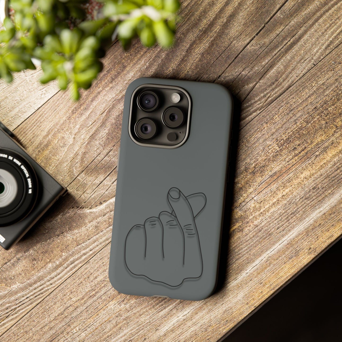 Silicone phone case with embossed Korean finger heart design, compatible with smartphones, by Printify.