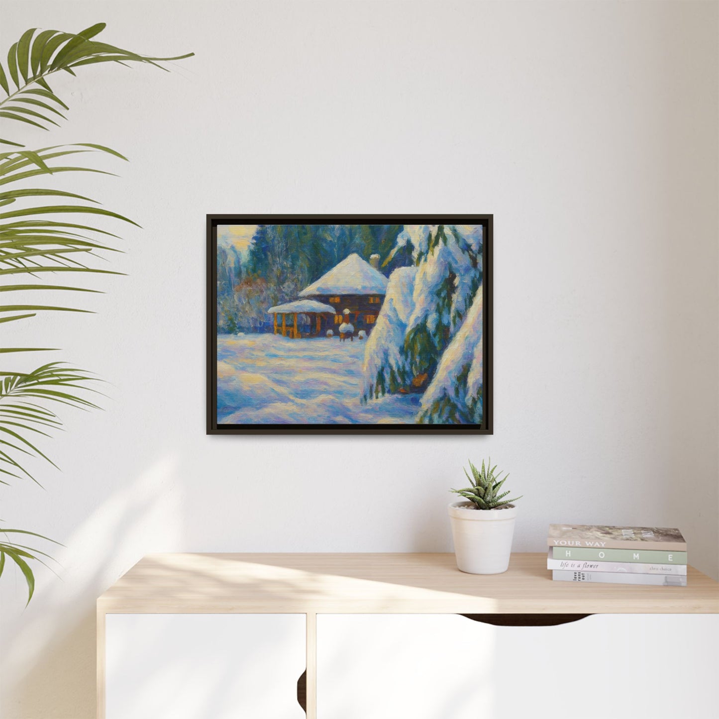 Framed matte canvas wall art featuring a snowy cabin winter landscape, showcasing a cozy winter scene by Printify.