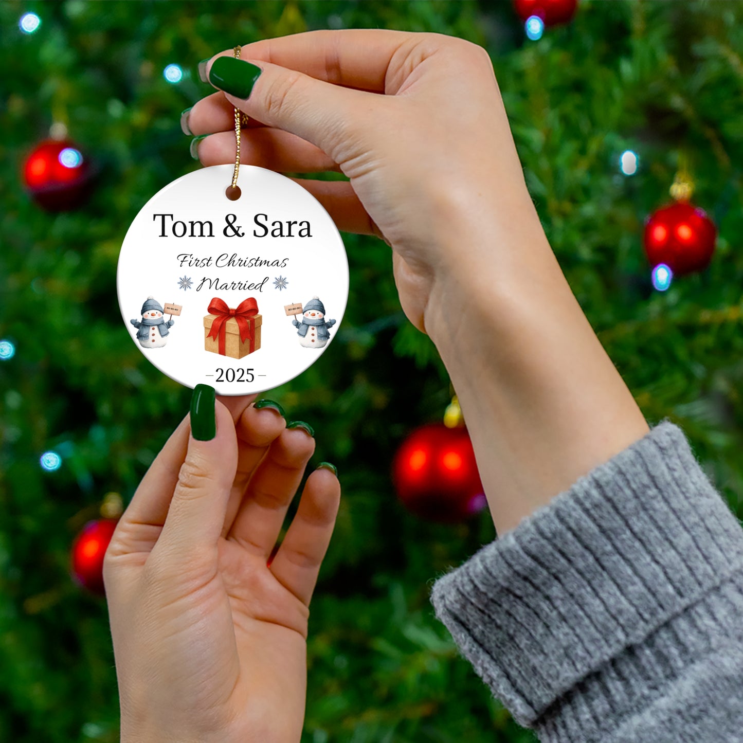 Personalized ceramic Christmas ornament with "Tom & Sara First Christmas Married 2025" message, featuring festive design and custom text.