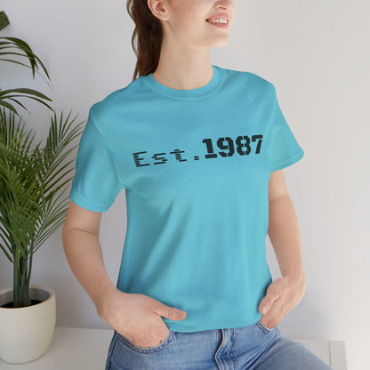 Vintage Est. 1987 T-Shirt by Printify featuring bold "Born 1987" graphic on soft cotton fabric, perfect for retro style.