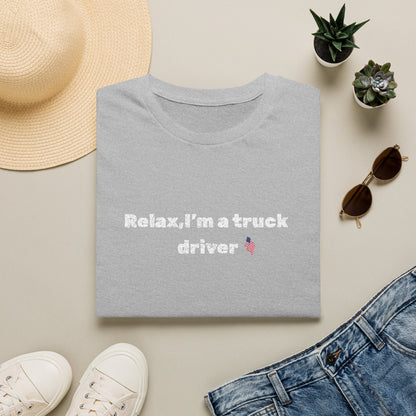 Pink heart graphic on a white Relax, I'm a Truck Driver T-Shirt featuring a humorous trucker slogan, casual and comfortable fit.