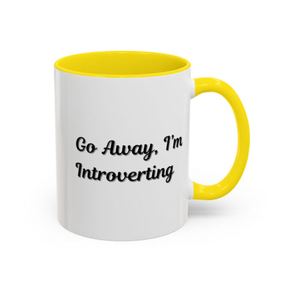 Ceramic coffee mug with "Go Away, I'm Introverting" quote in black text, 11 oz, ideal for introverts.