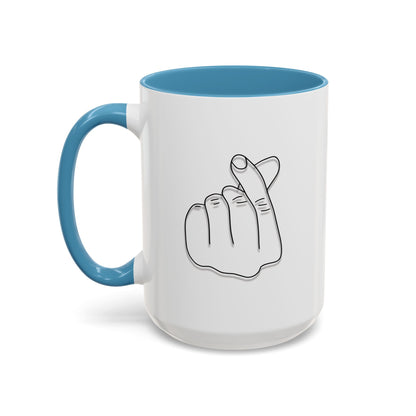 White ceramic coffee mug with minimal Korean finger heart accent design, available in 11oz and 15oz sizes.