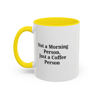 Ceramic coffee mug with "Not a Morning Person, Just a Coffee Person" print, ideal for morning beverages and everyday use.