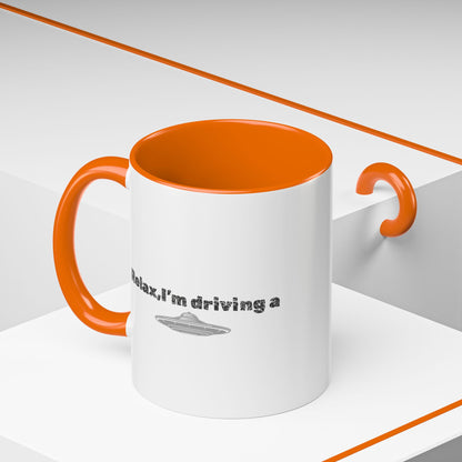 Ceramic coffee mug with UFO accent and "Relax, I’m Driving" text, available in 11 or 15 oz sizes, by Printify.