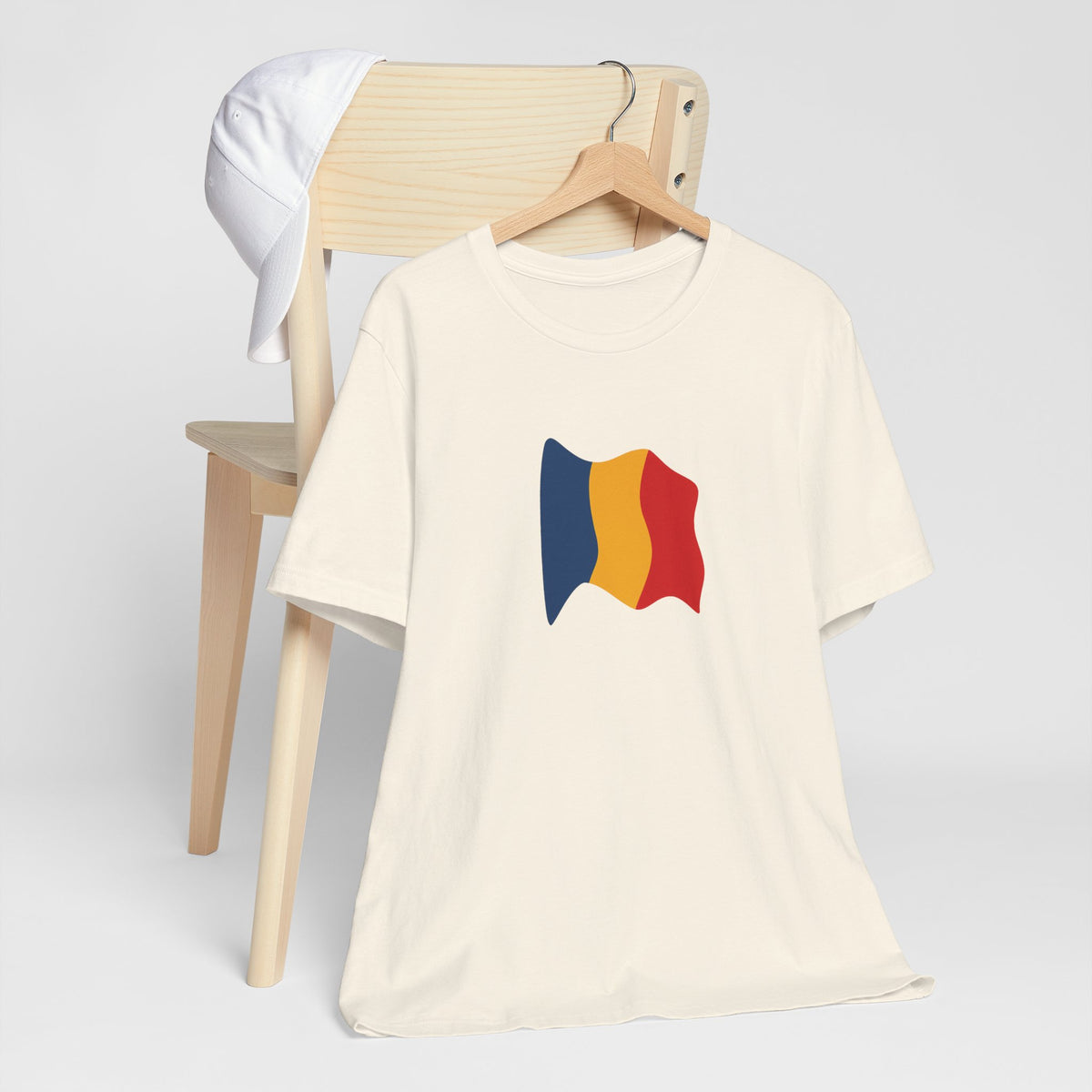 Romania flag T-shirt featuring a minimal waving tricolor design, casual unisex tee by Printify.