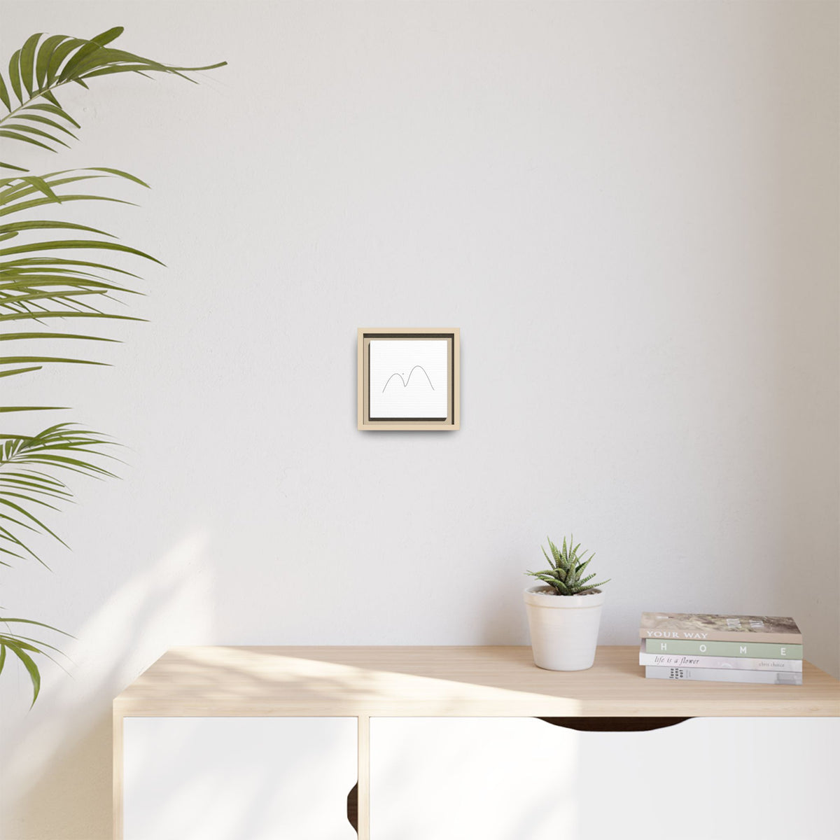 Framed minimalist mountain line art on matte canvas, modern wall decor by Printify featuring simple mountain outline design.