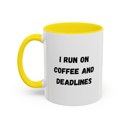 White ceramic coffee mug with black text saying "I Run on Coffee and Deadlines," featuring a simple design.