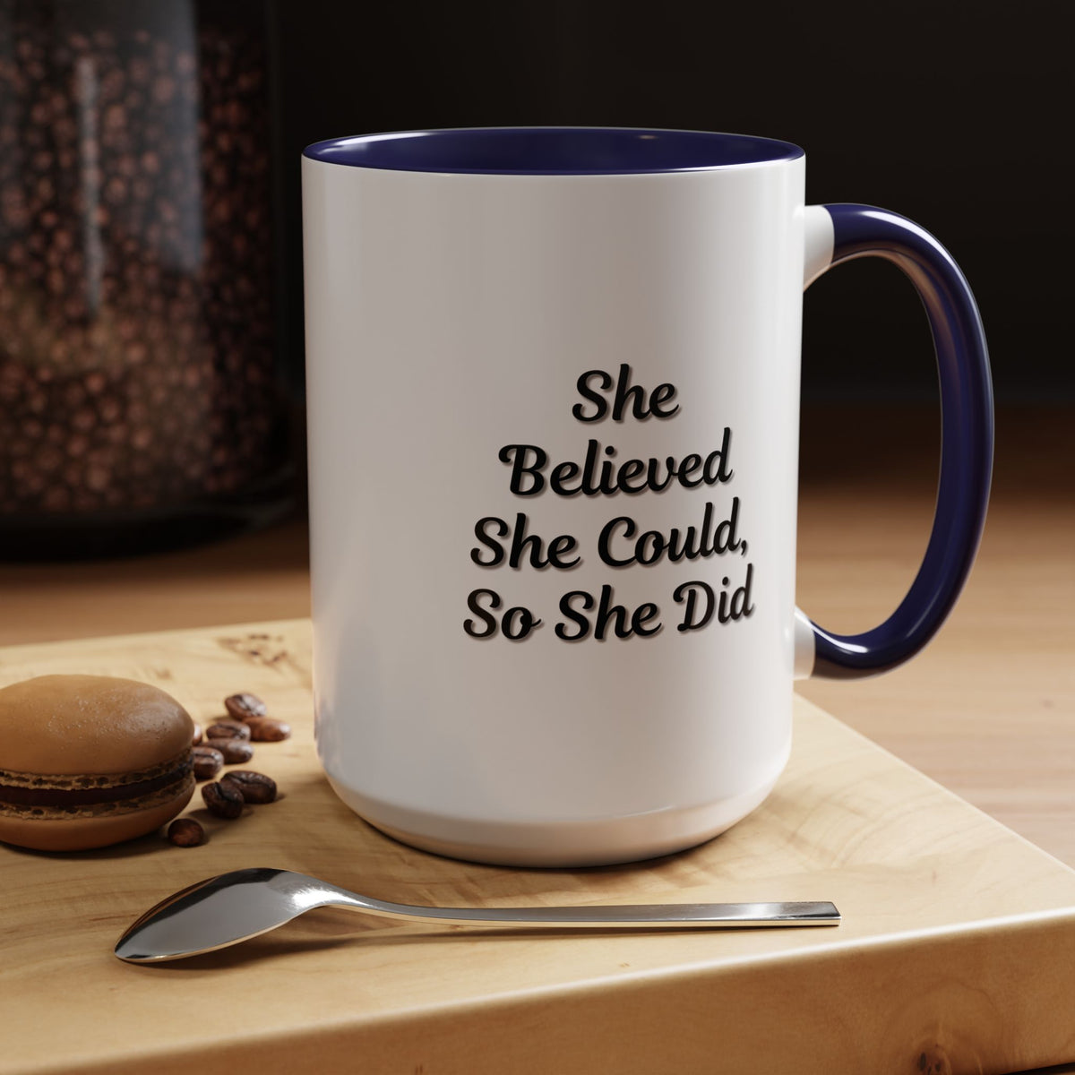 White ceramic motivational coffee mug with black text reading "She Believed She Could, So She Did" from Printify.